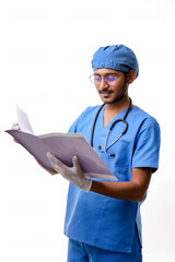 Young indian Doctor checking out some reports over white backgro