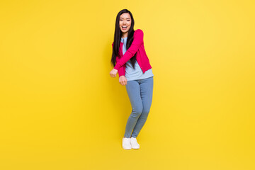 Fototapeta na wymiar Full body photo of funny brunette millennial lady dance wear pink sweater jeans isolated on yellow background