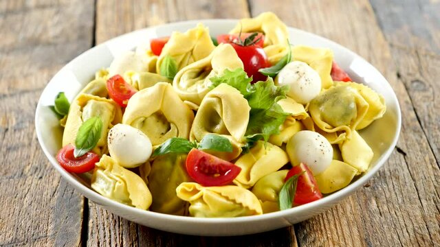 bowl of ravioli, tortellini with tomato and mozzarella
