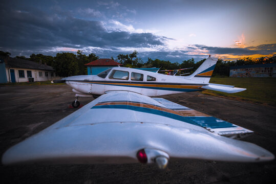 Light single engine school airplane parked on airfield
