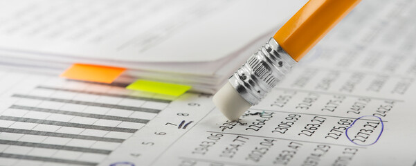 Accounting document with eraser erases blots in the document and checking financial chart. Concept...