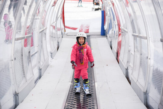Happy Malaysian kid in a ski resort