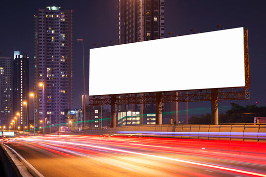 White Blank billboard on light trails, street, city and urban in the dusk or night- can advertisement for display or montage product or business.
