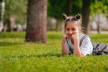 Fototapeta premium the girl is lying on the green grass