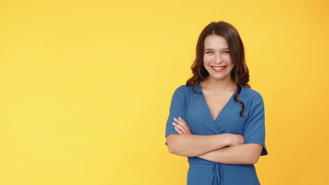 Good choice. Advertising people. Perfect solution. Portrait of satisfied happy smiling woman pointing finger at something invisible isolated on orange copy space background.