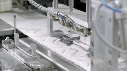 Mattress production machine in factory.