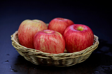 ripe red apple isolated in wicker basket