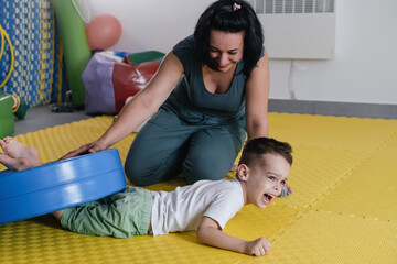 Rehabilitation of children with cerebral palsy. Physical activities for disabled kids in center....