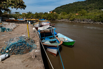 Naklejka na ściany i meble Colorful fishing boats in the port of Rio Preto in Peruíbe city.