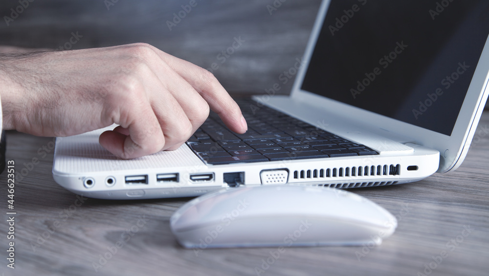 Wall mural Male hand typing on computer keyboard.