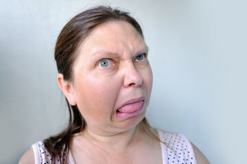 European elderly woman shocked by what is happening, facial expressions, face close-up, concept...