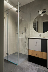 Stylish composition of modern bathroom interior. Modern designed shower, mixed wooden commode, mirror and personal accesories. . Minimalistic masculine concept. Template.