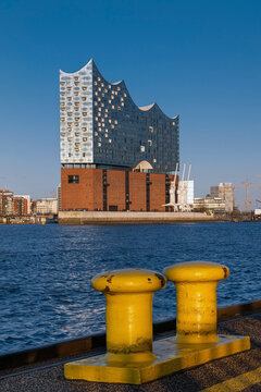 Hamburg, Germany - March 16, 2020: The Concert Hall Elbphilharmonie with yellow bollards in the foreground.