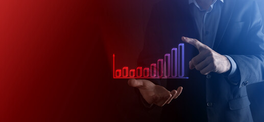 Businessman hold drawing on screen growing graph, arrow of positive growth icon.pointing at creative business chart with upward arrows.Financial, business growth concept.