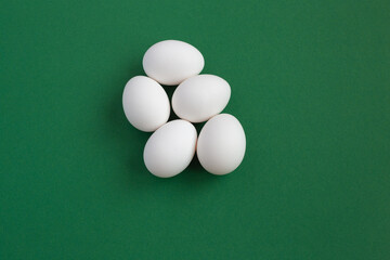 white eggs on a green background
