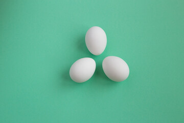 white eggs on a green background