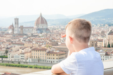 Fototapeta na wymiar Young boy looking on panoramic view of Florence, Italy