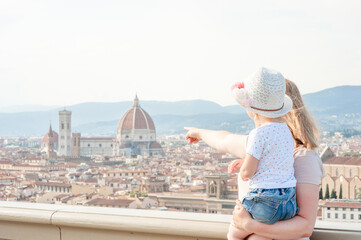 Family traveling. Woman with kid look on panoramic view of florence, Italy