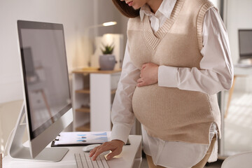 Pregnant woman working at home, closeup. Maternity leave