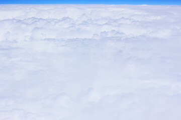 Cloud and sky pastel colors abstract nature background. airplane and green landscape, river, mountain, clouds background. View from the airplane window. Airplane wing flying above the clouds. Top view