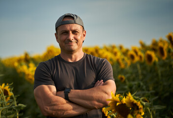 Happy farmer in his sunflower plantation