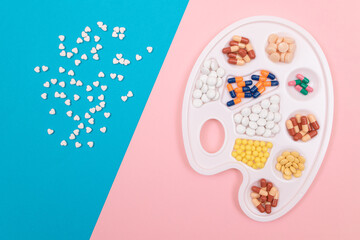 Global Pharmaceutical Industry and Medicinal Products - Different Colored Pills, Tablets and Capsules on White Art Palette Lying on Split Blue and Pink Background, Flat Lay