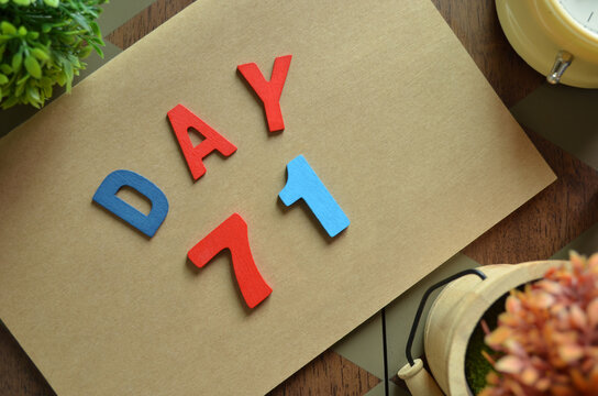 Day 71, cover design in natural concept with the alphabet on brown notebook on the wooden table for a background.