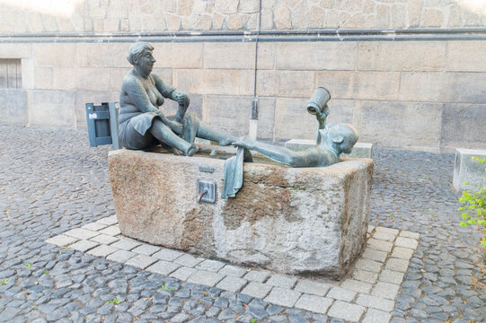 Gorlitz, Germany - June 2, 2021: Fountain with a couple of revelers at Klosterplatz.