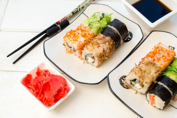 Several sushi on a white plate standing on a white background
