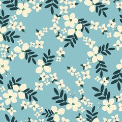 Vintage floral background. Seamless pattern for design and fashion prints. The flowers are milky with dark leaves on a light blue background.