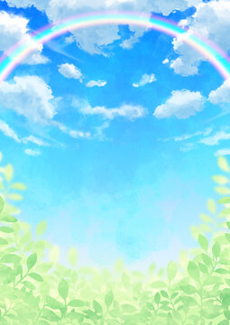 虹のかかった青空と雲と葉っぱ
