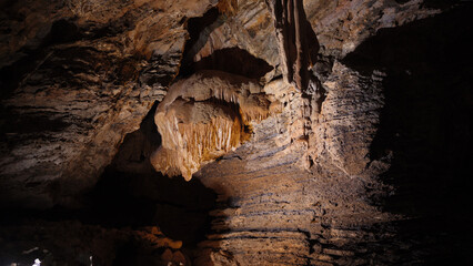 Cave formations within the caverns of Mole Creek, in Tasmania, Australia. Limestone formations with varied lighting and cave river. 
