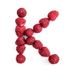 The letter K of the english alphabet of red ripe raspberries