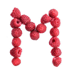 The letter M of the english alphabet of red ripe raspberries