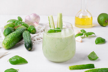 Green gazpacho with fresh cucumber, yogurt, herbs, garlic and olive oil served in glass. Spanish cold soup