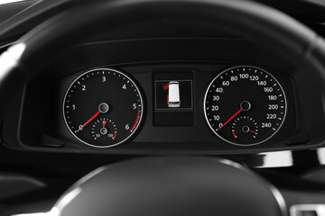 Modern speedometer, tachometer and open door warning sign on car dashboard