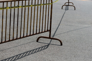 antique crowd control barrier fence with yellow caution tape