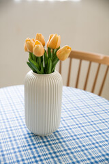 home interior decoration a bouquet of tulips in a vase on table.