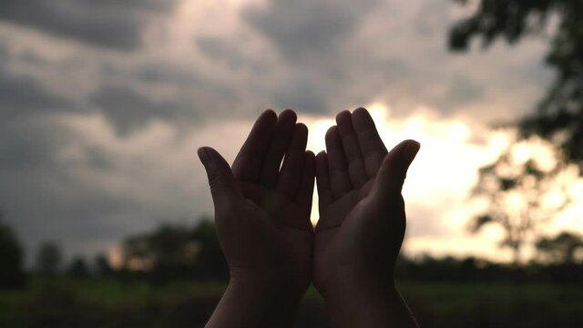 B roll 4k. of Human hands open palm up worship god with sunset like hope. Eucharist Therapy Bless God Helping Repent Catholic Easter Lent Mind Pray. Christian Religion concept background. Victory god.