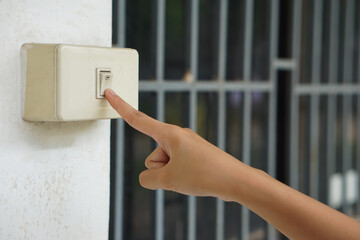Hand turned off light switch before leaving the room or after finish using electric light. Concept...