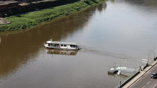 A ferry with passengers crosses the river Elbe
