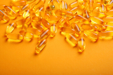 Omega 3 capsules on a colored background close-up with place for text.