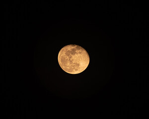 The Moon glowing with rugged texture in the night sky