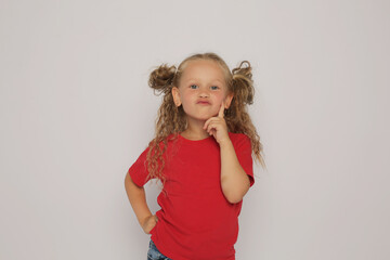 a beautiful blonde girl with ponytails in a red T-shirt shows various emotions sadness ,surprise, fear ,happiness