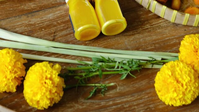 Healthy Jamu drink- Indonesian herbal beverage in glass bottle with natural ingredients: turmeric, ginger, lime, palm sugar, lemongrass, tamarind on wooden table. Healthy lifestyle