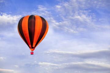 Red hot air balloon flying on blue sky