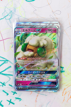 Hamburg, Germany - 07222021: Photo of the japanese pokemon double blaze holo card Whimsicott GX lying on kids desk. The Pokemon TCG is a collectible card game and investment possibility.
