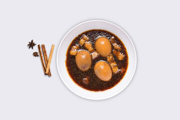 Stewed eggs with pork in a white plate isolated on light gray background - Clipping path