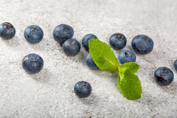 Fresh Blueberries on lihgt grey concrete table