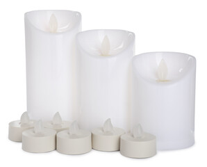 Different decorative flameless LED candles on white background